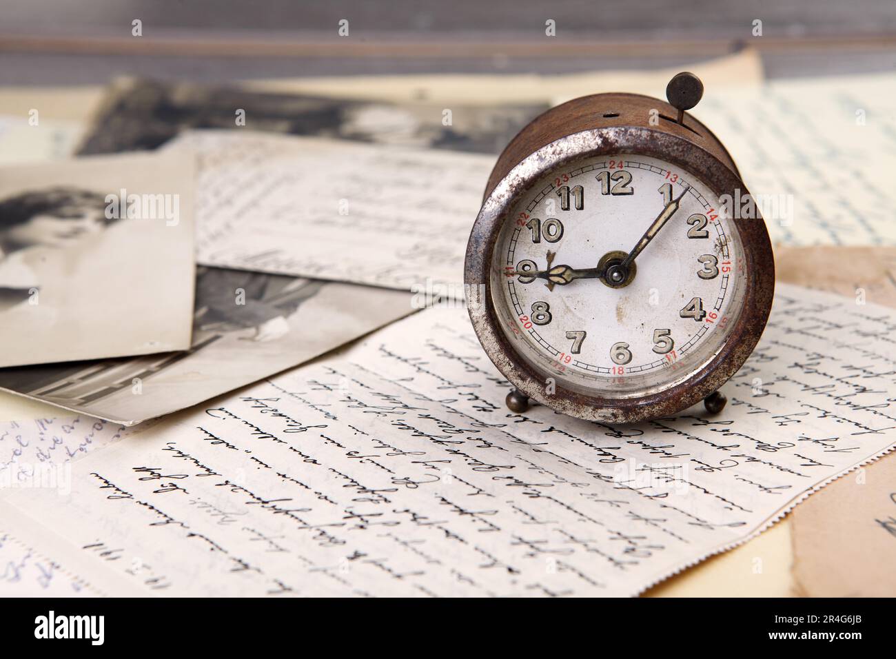 Old rusty mechanical alarm clocks and handwritten letters Stock Photo