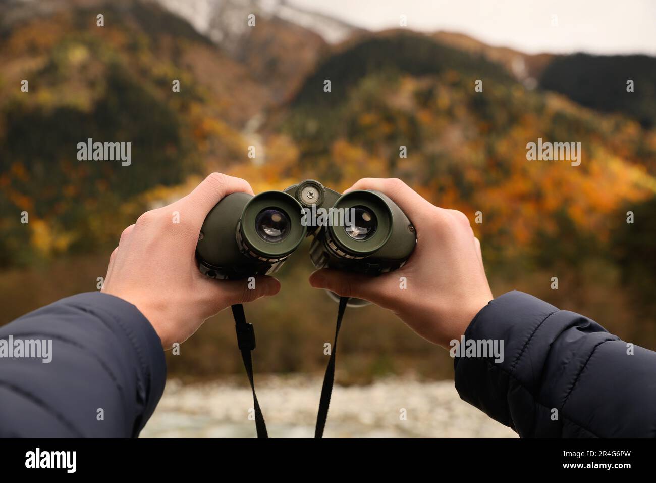 Boy holding binoculars in beautiful mountains, closeup Stock Photo - Alamy