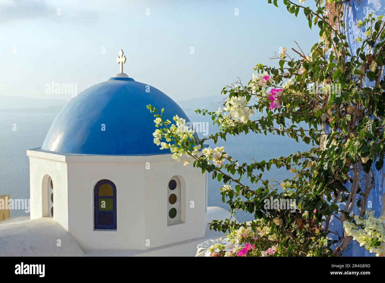 Church with flowers on Santorini, Greece Stock Photo