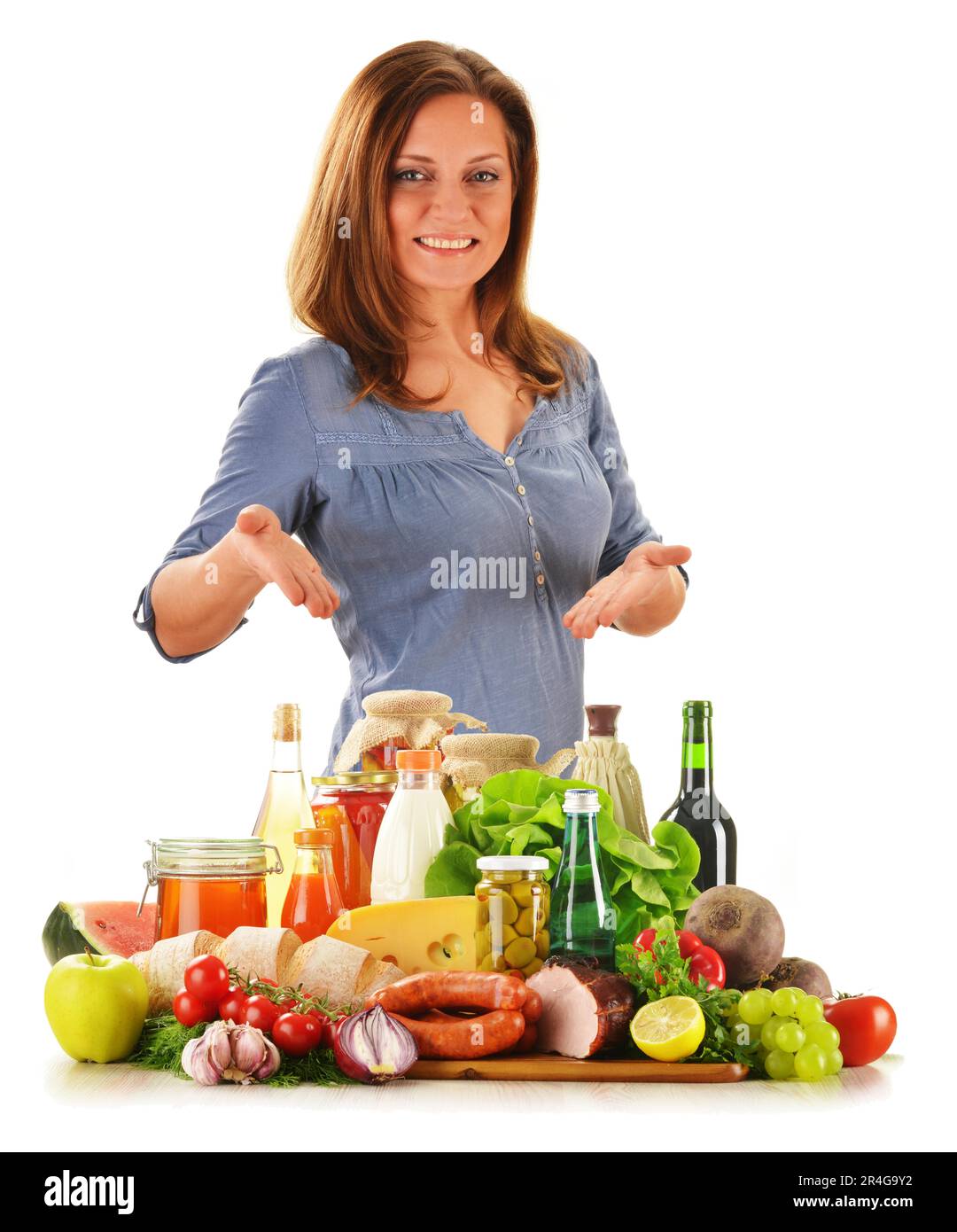 Young woman with variety of grocery products isolated on white Stock Photo