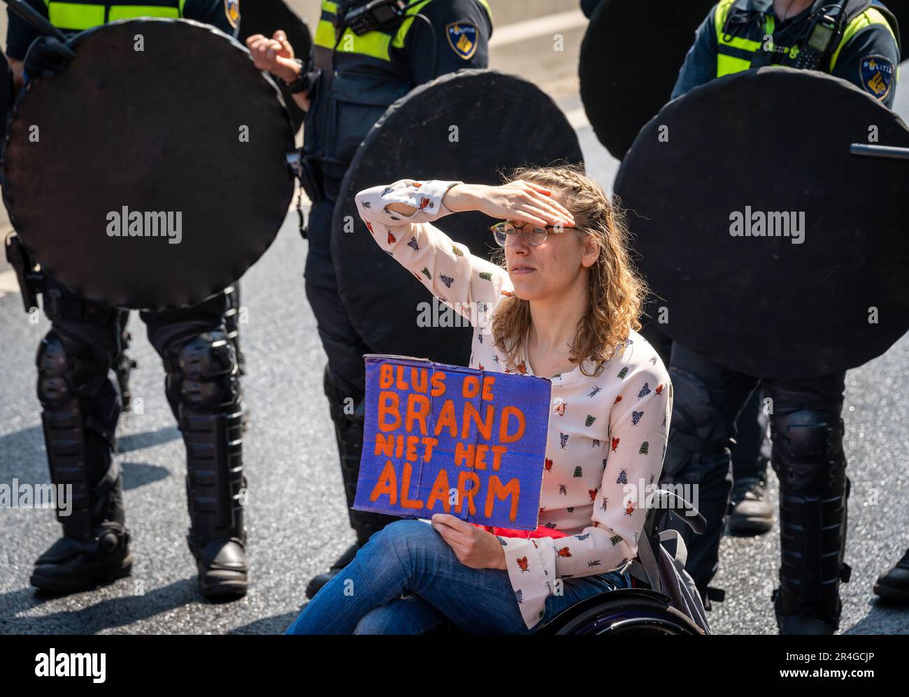 The Hague, The Netherlands, 27.05.2023, Climate activist with placard during protest action of Extinction Rebellion movement in The Hague Stock Photo