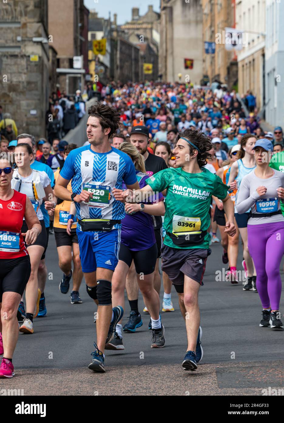 Edinburgh, Scotland, UK, 28th May 2023. Edinburgh Marathon: some of thousands of marathon runners run down the Royal Mile in the early stage of the route. Credit: Sally Anderson/Alamy Live News Stock Photo