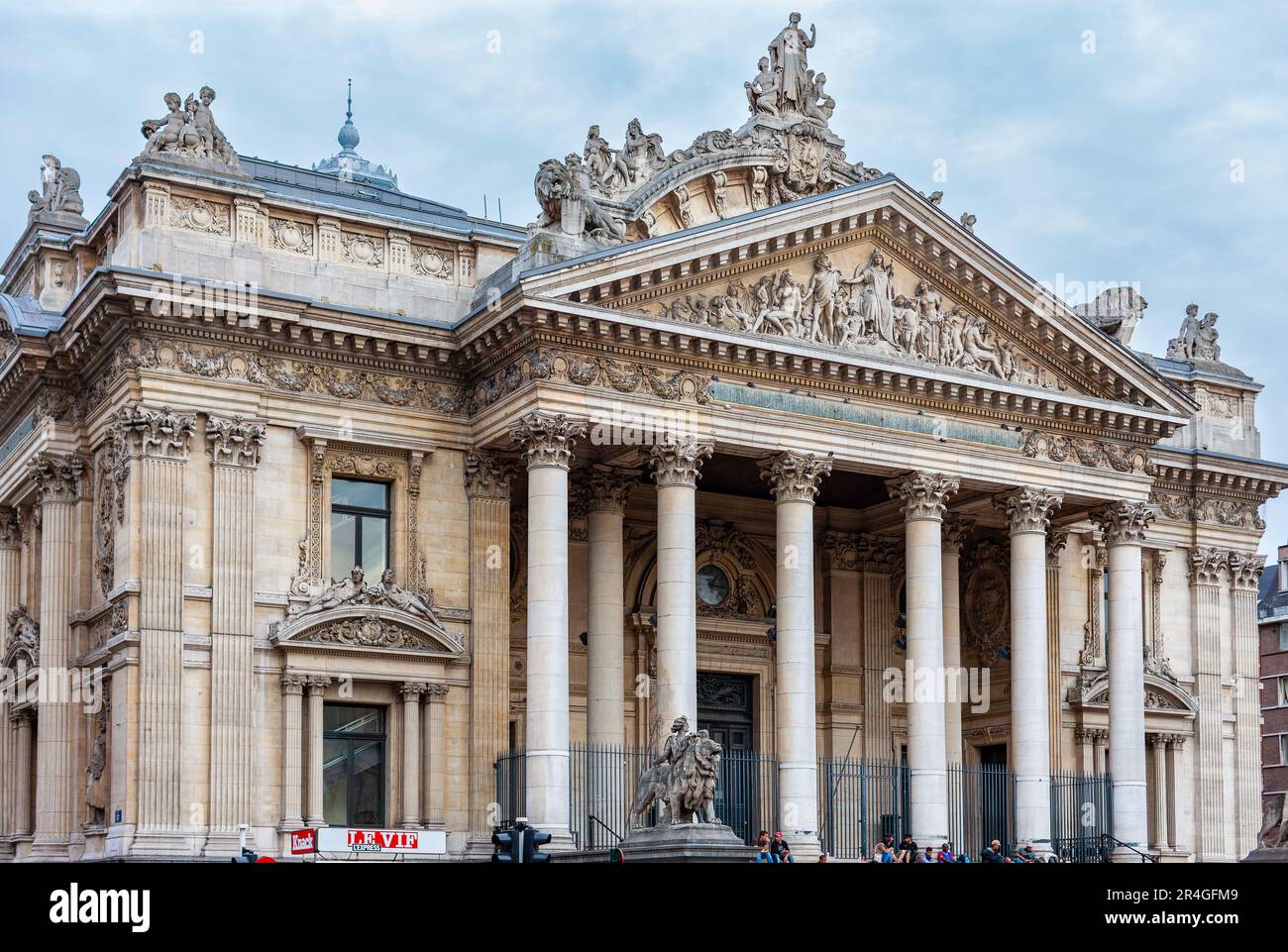 Brussels, Belgium - July 6, 2010 : Brussels Stock Exchange,  People sitting and relaxing on the steps of the Neo-Palladian financial building. Stock Photo