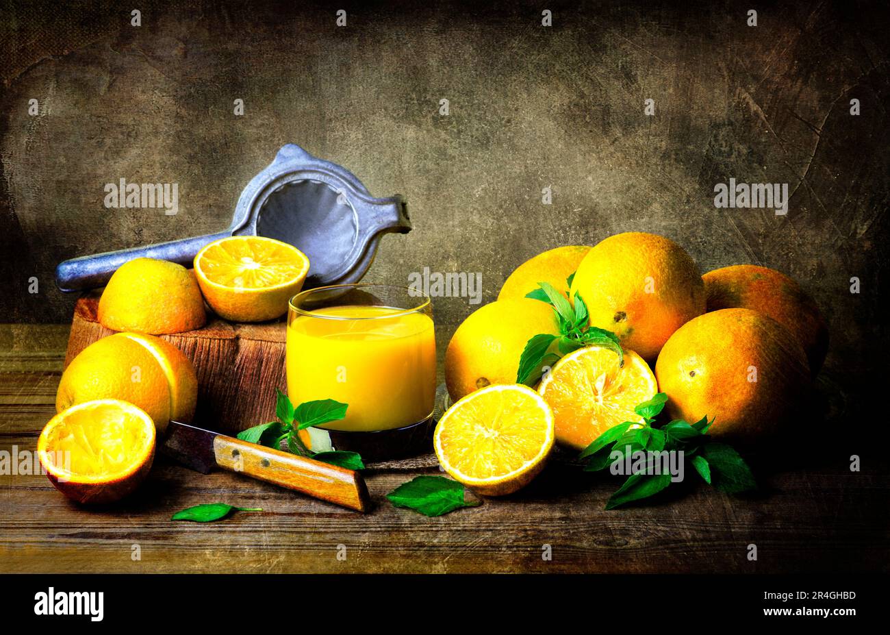Classic Still life with delicious organic Oranges, glass of fresh orange juice placed together on rustic wooden table. Stock Photo