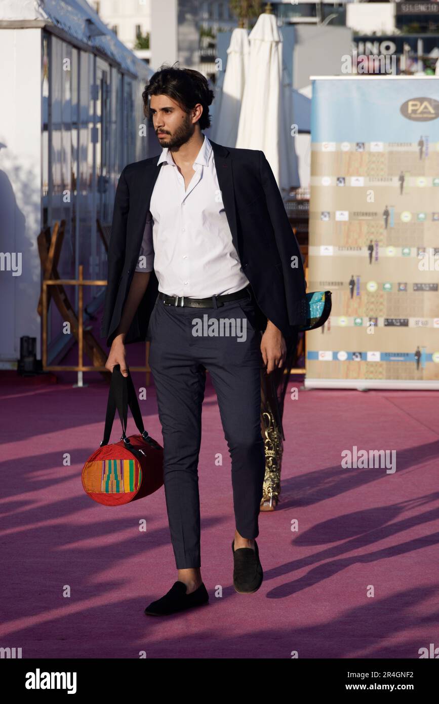 Cannes, France. 25th May, 2023. Model Atef Kazdaoui wears jewelry of Kitat Créations by designer Namema Christelle Traore walks the runway Stock Photo
