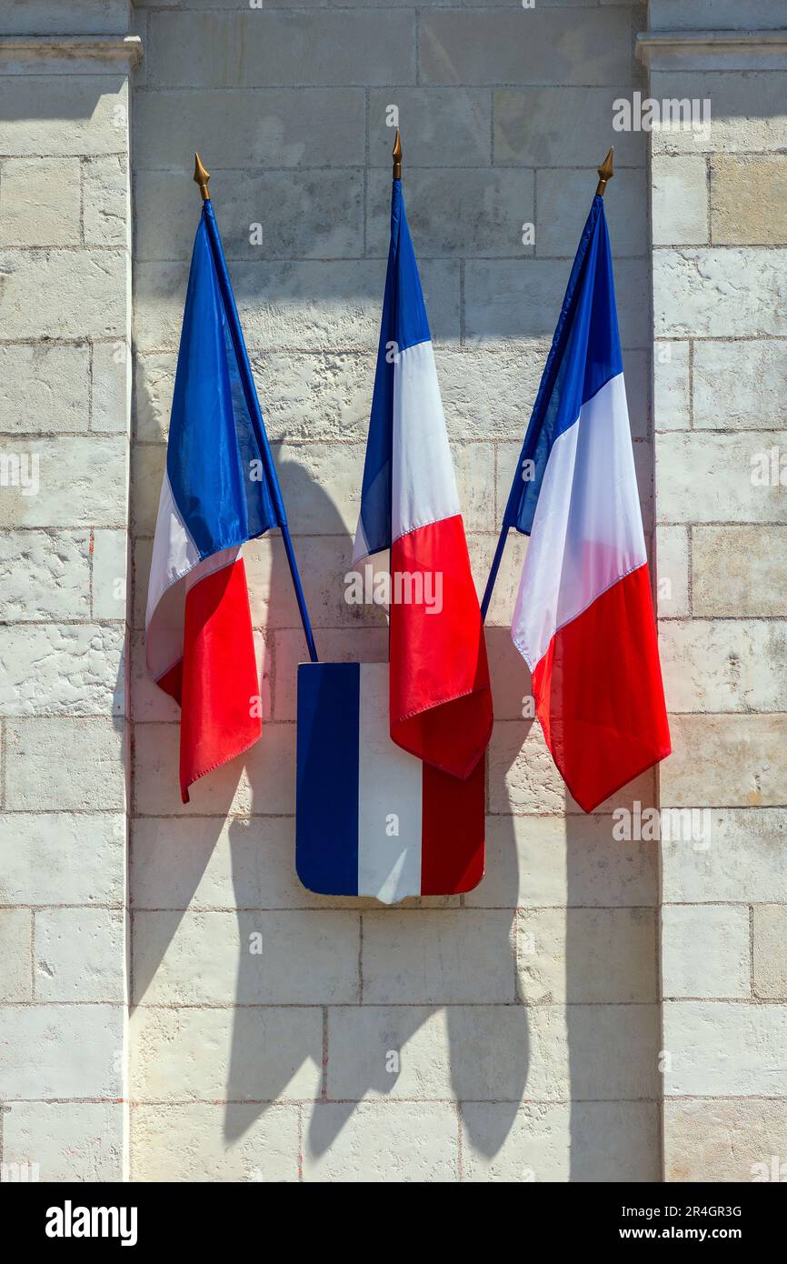 Trhee French tricolour flags and shield on government building - Tours, Indre-et-Loire (37), France. Stock Photo