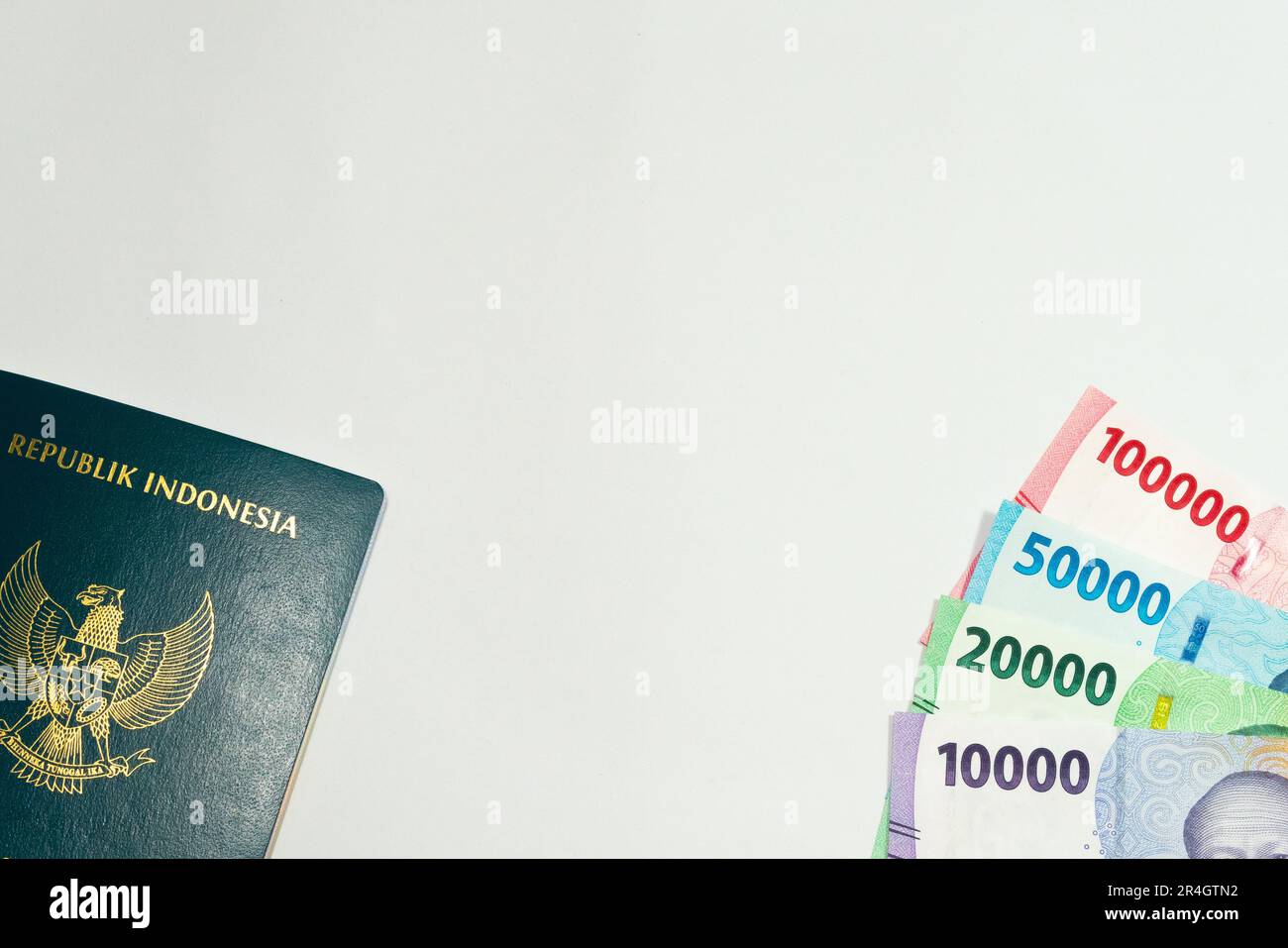 Indonesia passport and 10000, 20000, 50000, and 100000 rupiah currency ...