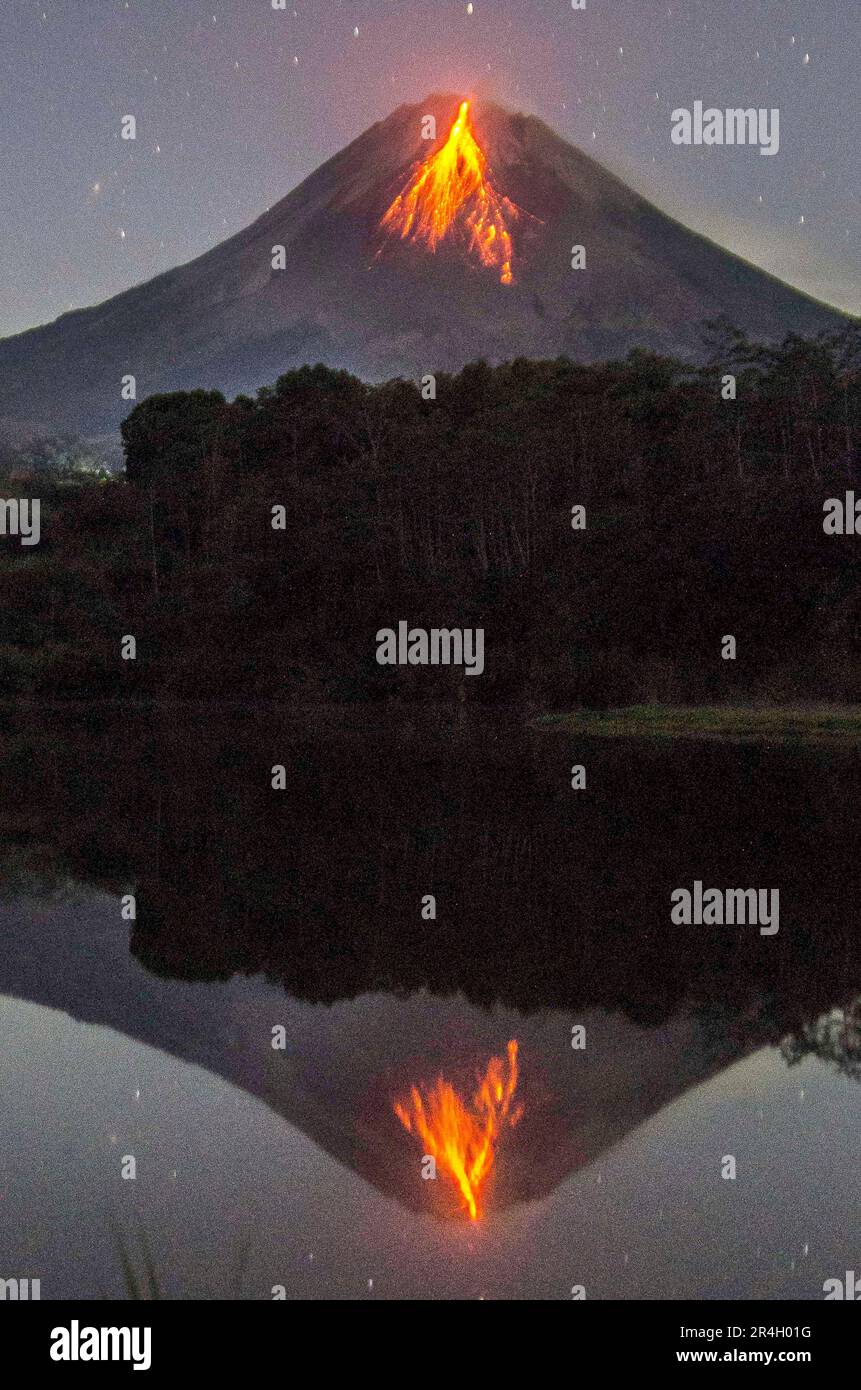 Magelang, Indonesia. 28th May, 2023. This long exposure photo shows volcanic materials spewing from Mount Merapi volcano, as seen from Srumbung village in Magelang, Central Java, Indonesia, on May 28, 2023. Credit: Agung Supriyanto/Xinhua/Alamy Live News Stock Photo