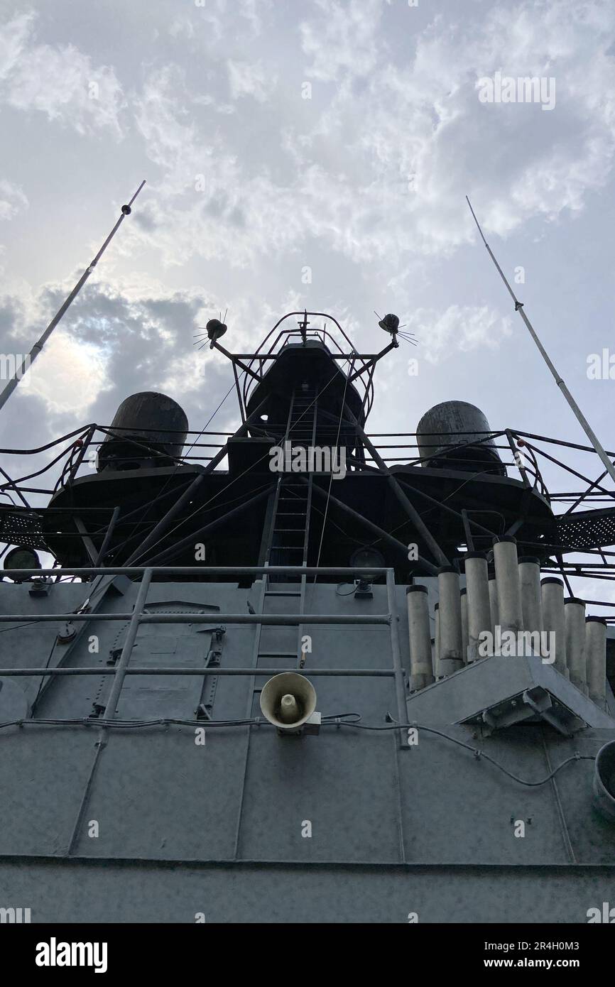 Outside details of retired vintage military naval sea vessel navy warship number, heavy machine gun, nautical flag, antenna, bridge of destroyer Stock Photo