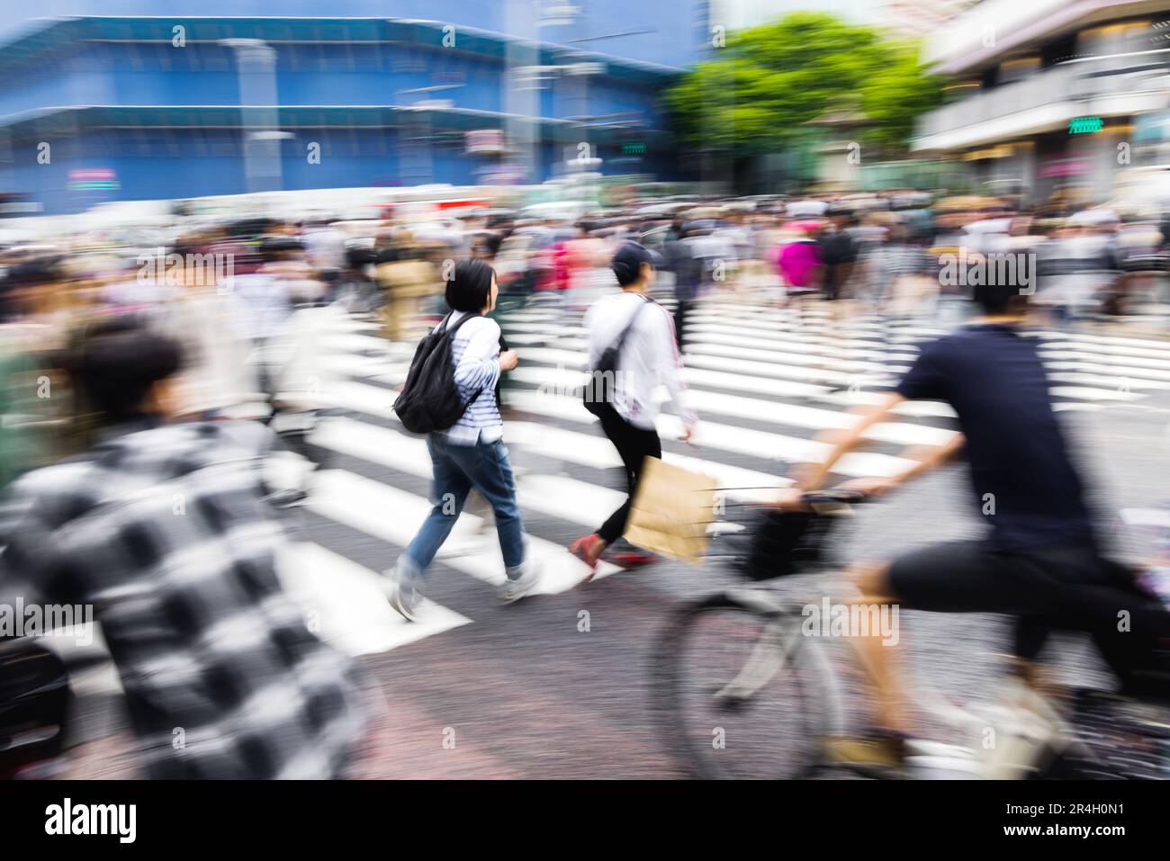 picture with camera made motion blur of a crowd of people crossing the ...