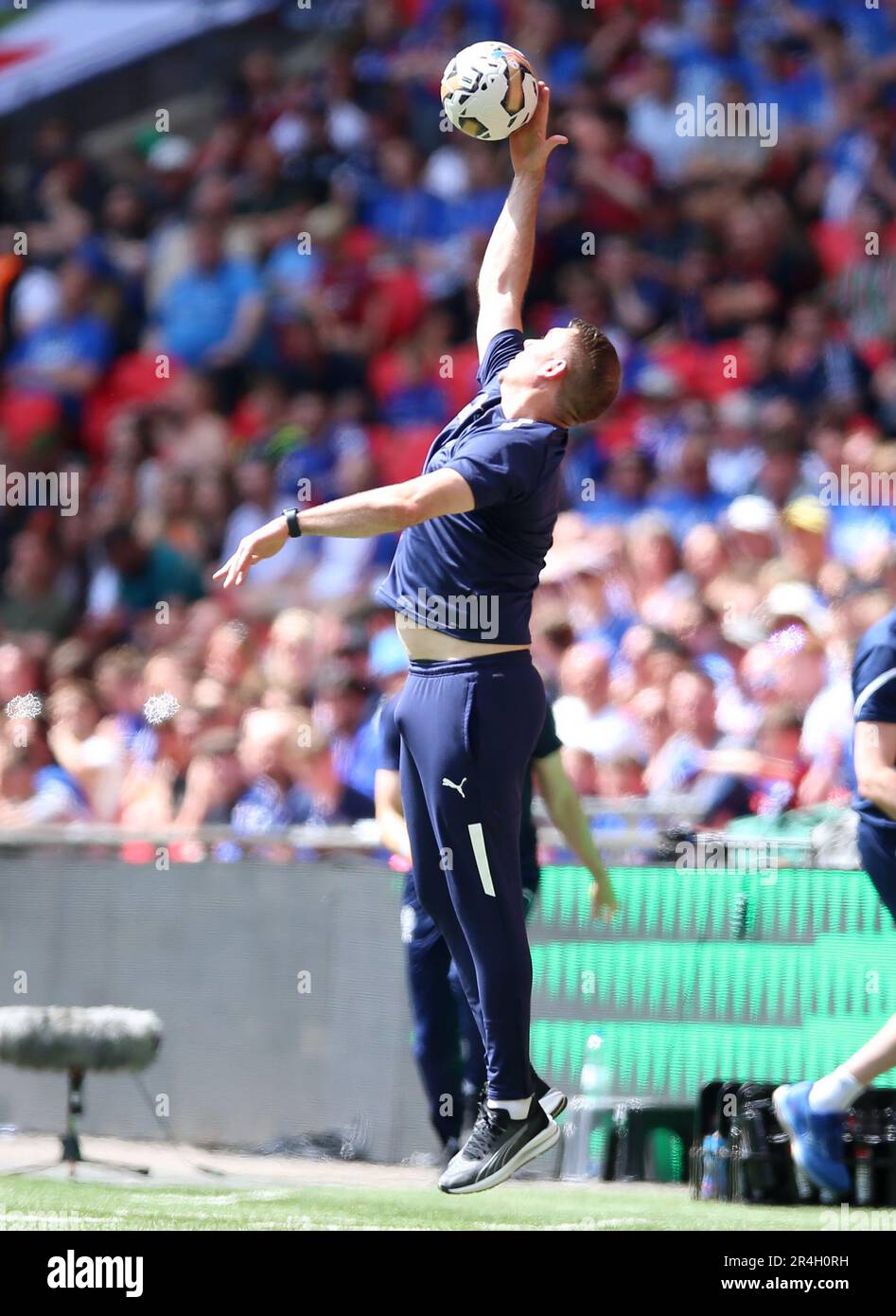 Stockport County manager Dave Challinor catches the ball on the