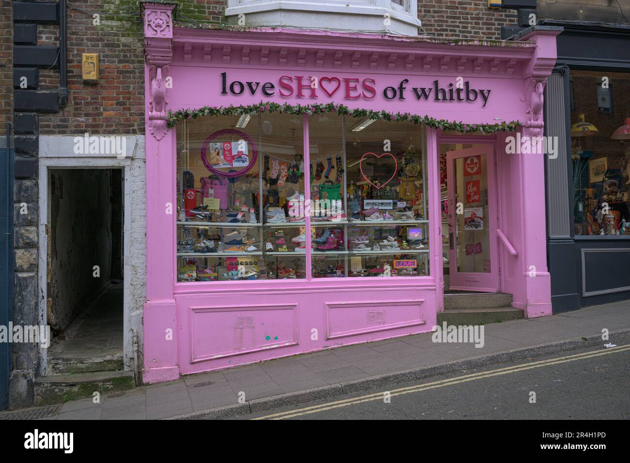 A Whitby Shoe shop with brightly coloured paint work and display in