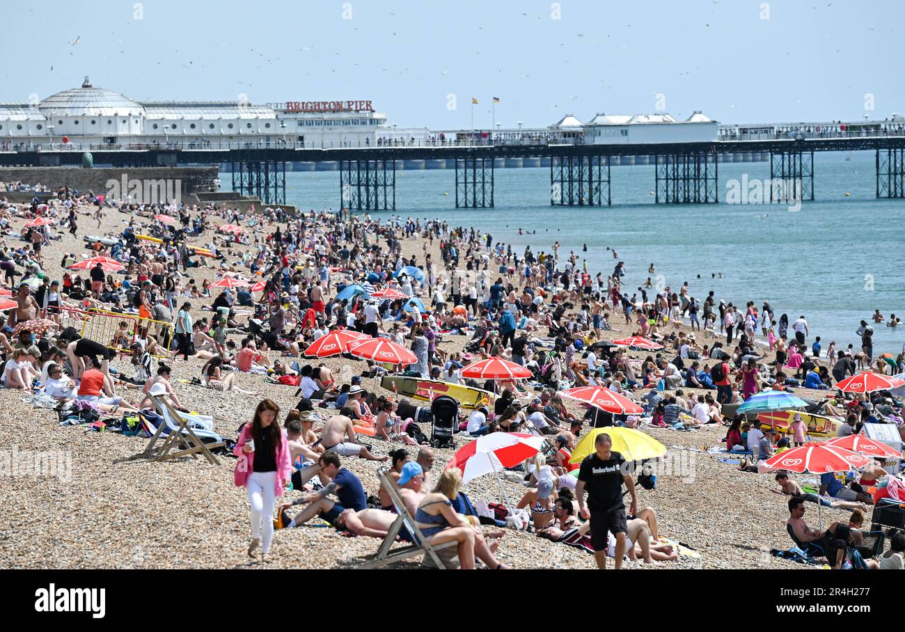 Brighton UK 28th May 2023 - Crowds enjoy a beautiful hot sunny day on Brighton beach during the bank holiday weekend with temperature reaching over 20 degrees in some parts of the UK : Credit Simon Dack / Alamy Live News Stock Photo