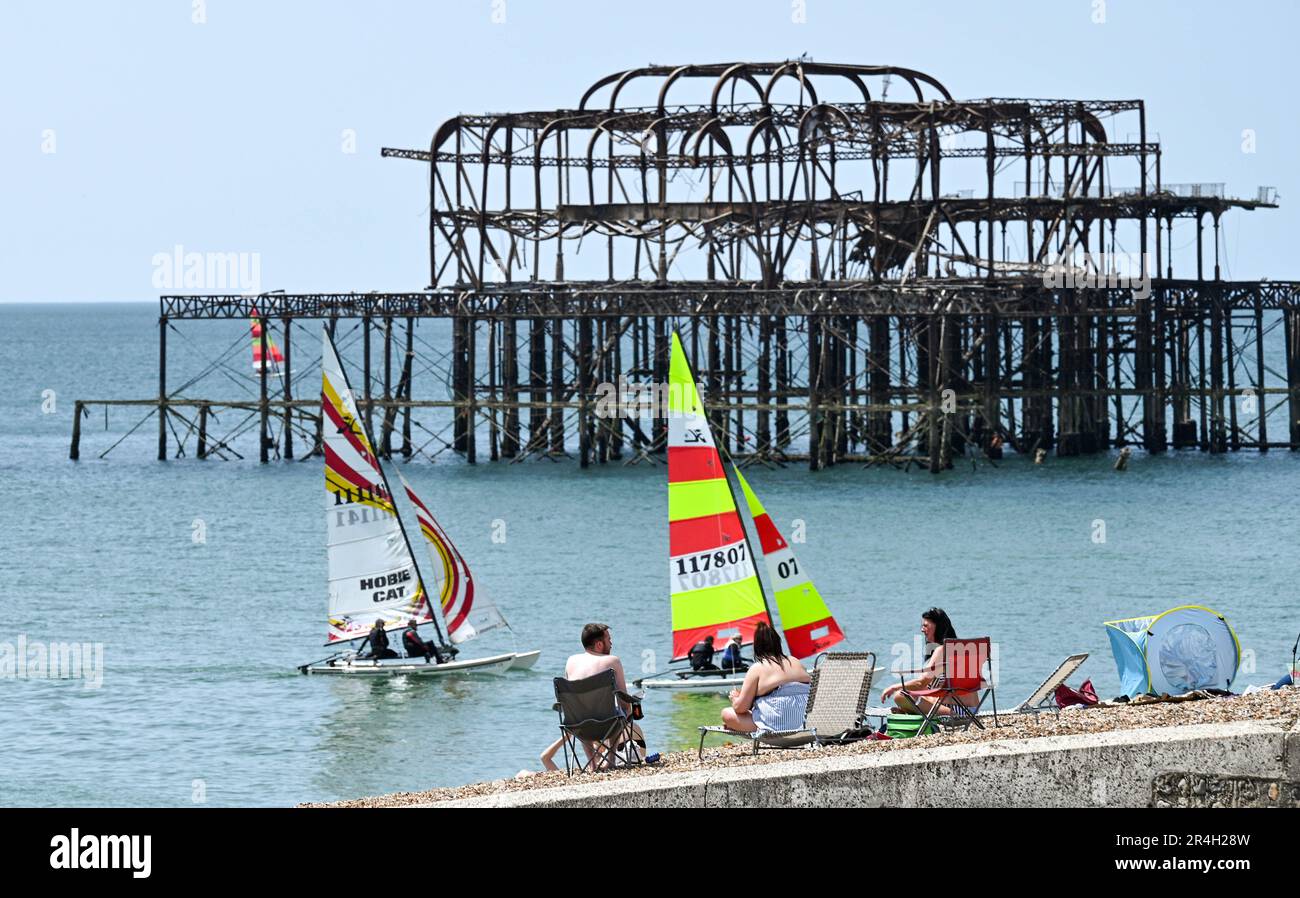 Brighton UK 28th May 2023 - Crowds and sailors enjoy a beautiful hot sunny day on Brighton beach during the bank holiday weekend with temperature reaching over 20 degrees in some parts of the UK : Credit Simon Dack / Alamy Live News Stock Photo