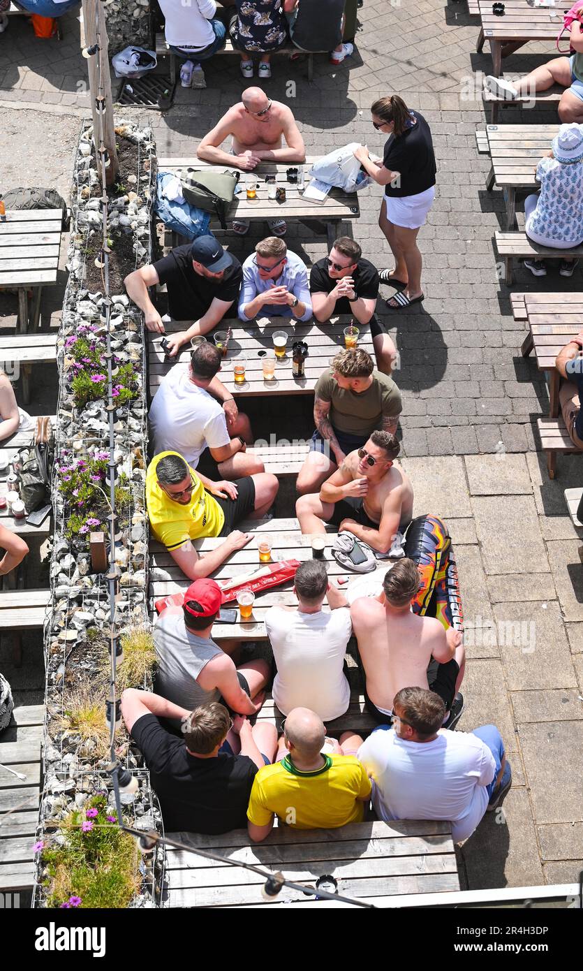Brighton UK 28th May 2023 - Brighton seafront bars are packed as crowds enjoy a beautiful hot sunny day during the bank holiday weekend with temperature reaching over 20 degrees in some parts of the UK : Credit Simon Dack / Alamy Live News Stock Photo