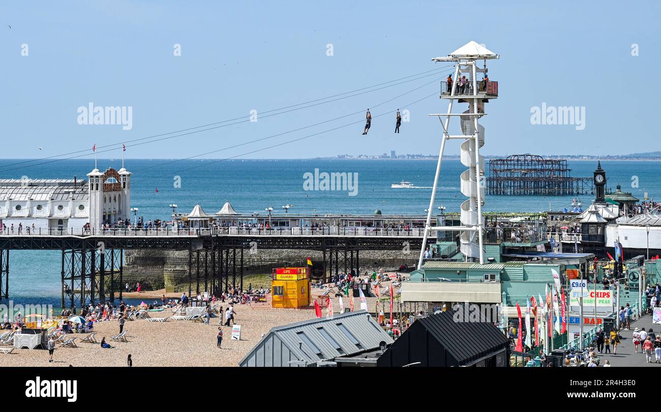 Brighton UK 28th May 2023 - Crowds enjoy a beautiful hot sunny day on Brighton beach during the bank holiday weekend with temperature reaching over 20 degrees in some parts of the UK : Credit Simon Dack / Alamy Live News Stock Photo