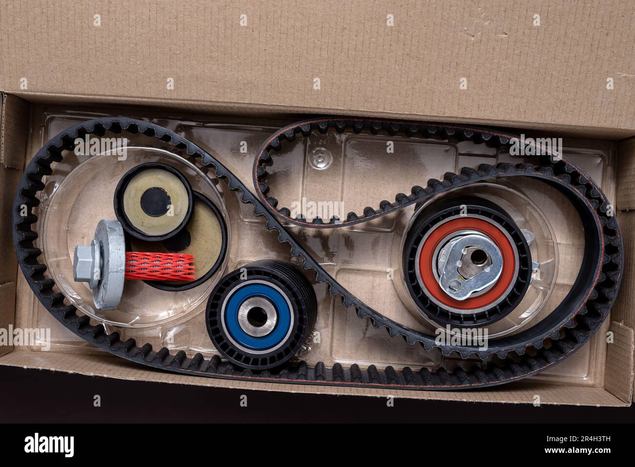 Repair kit for replacing the timing belt in a open cardboard box Stock