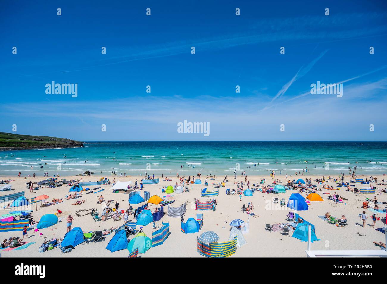 St Ives, UK. 28th May, 2023. People flock to the beach to sunbathe as well as take part in watersports and boat trips - Sunny weather for the bank holiday Credit: Guy Bell/Alamy Live News Stock Photo