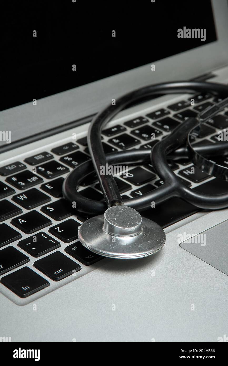 Medical stethoscope lies on the keyboard of a portable computer, part ...
