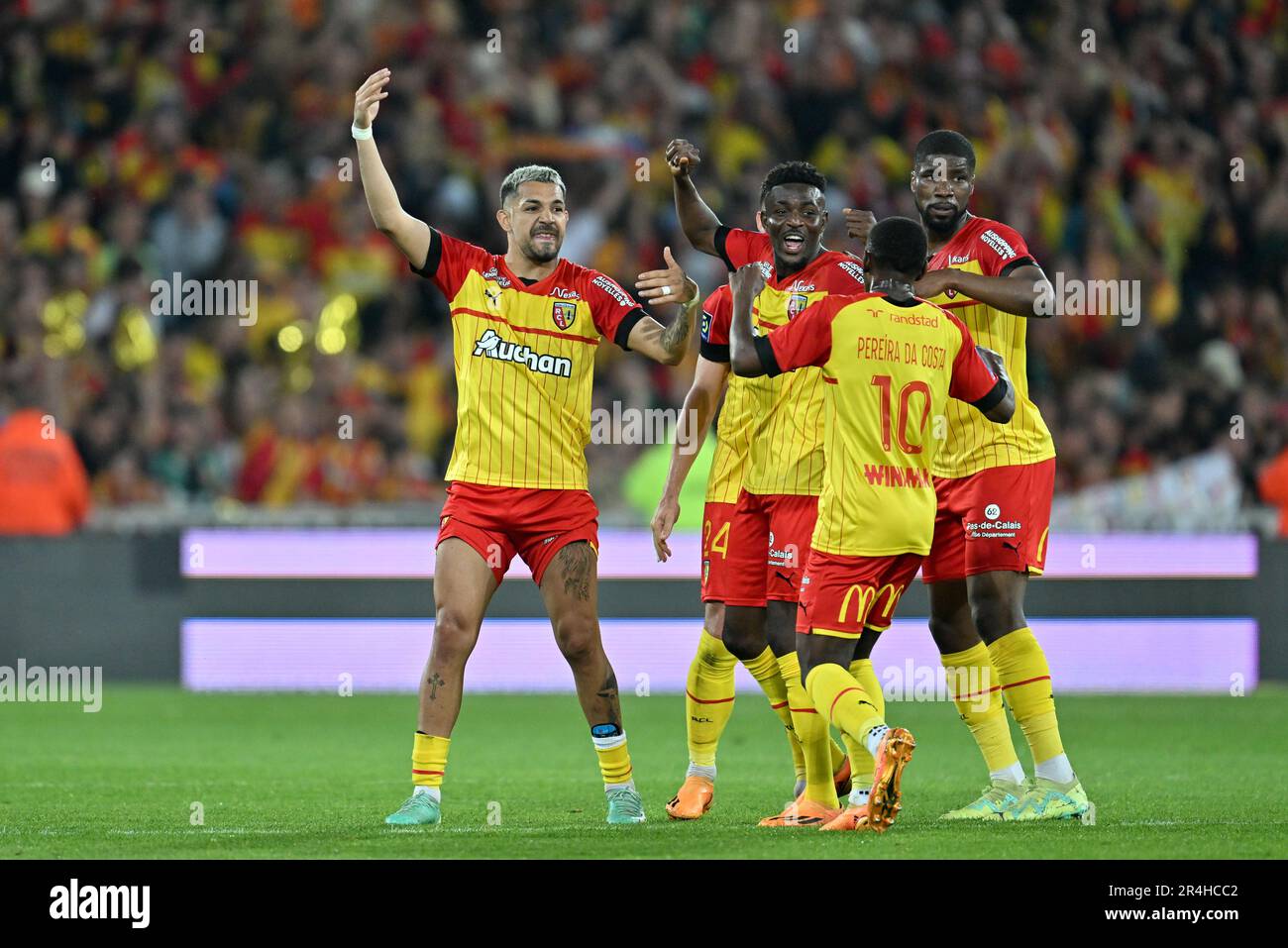 players of RC Lens and their president Joseph Oughourlian pictured  celebrating after winning and qualifying for the Champions League after a  soccer game between t Racing Club de Lens and AC Ajaccio