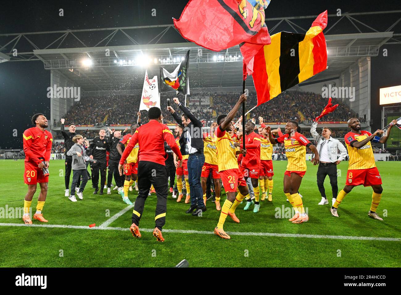 players of RC Lens and their president Joseph Oughourlian pictured  celebrating after winning and qualifying for the Champions League after a  soccer game between t Racing Club de Lens and AC Ajaccio