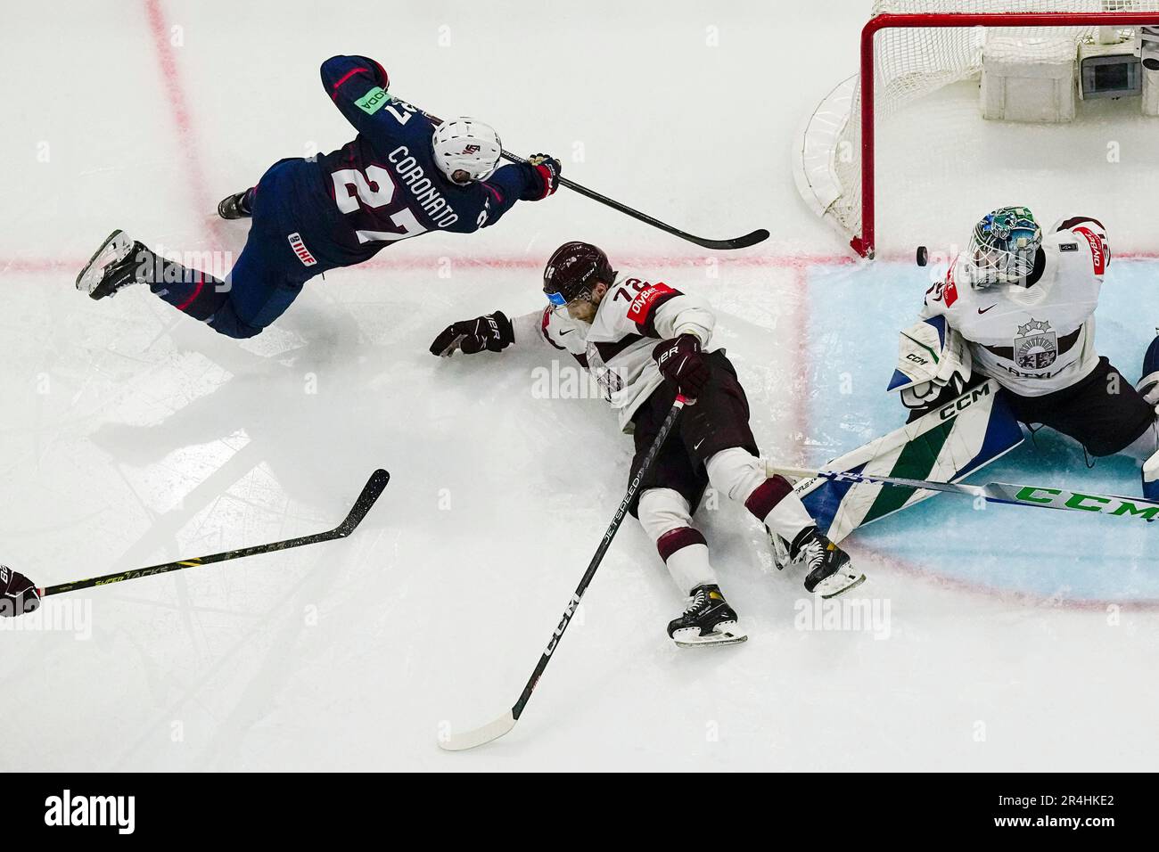 United States Matt Coronato (27) scores on Latvia's goalie Arturs