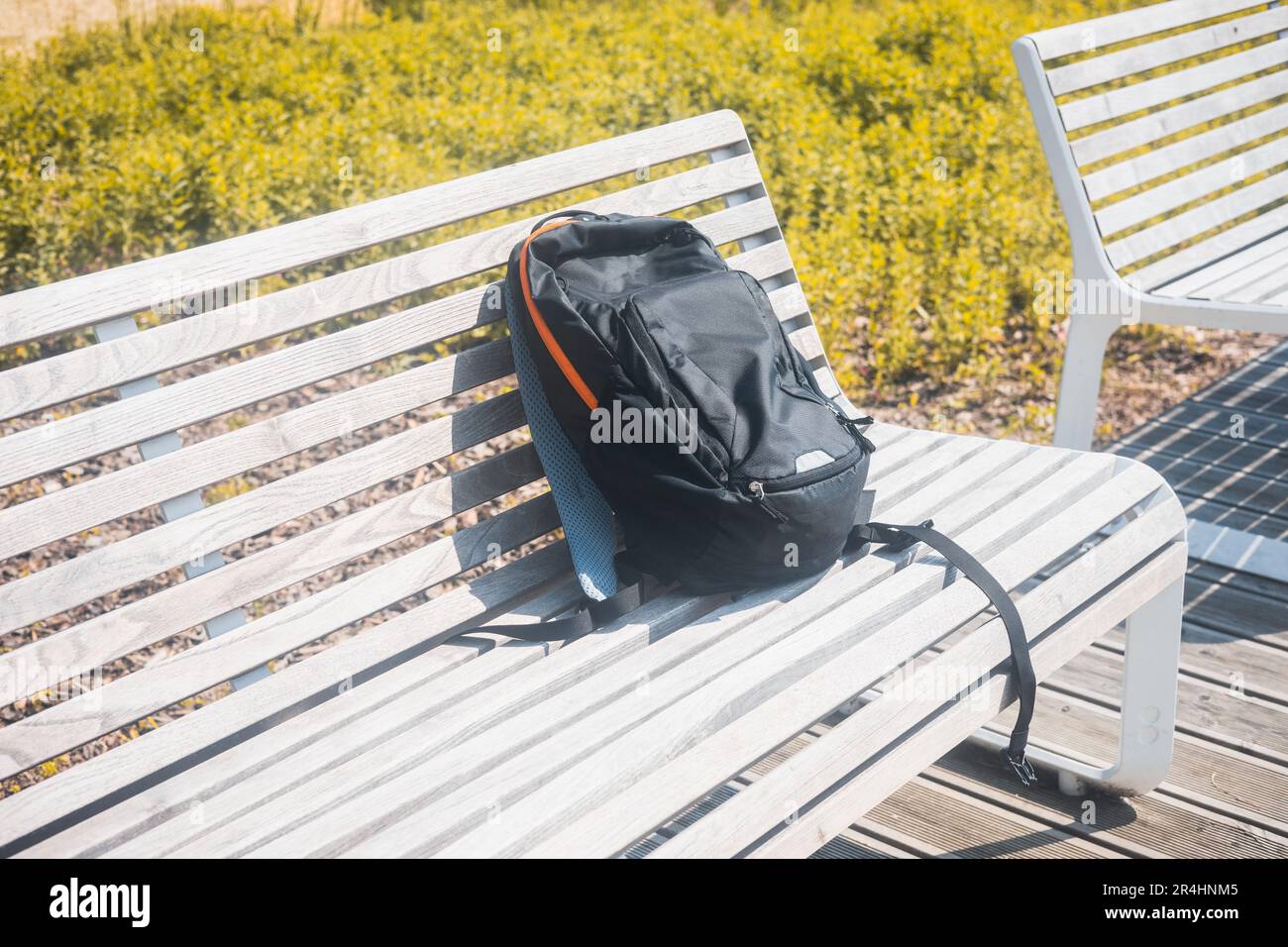 Backpack left on the bench, Concept, suspicious luggage, lost items Stock Photo