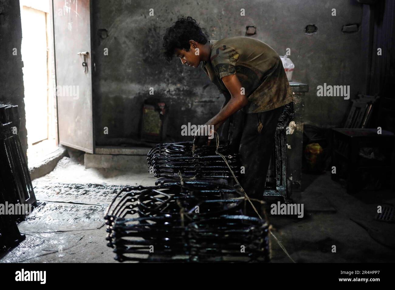 Dhaka, Bangladesh. 28th May, 2023. An underage boy is working at a