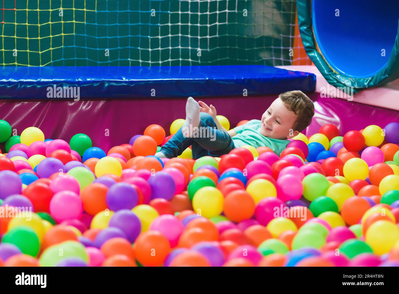 Happy laughing child laughing in an indoor play center. Children