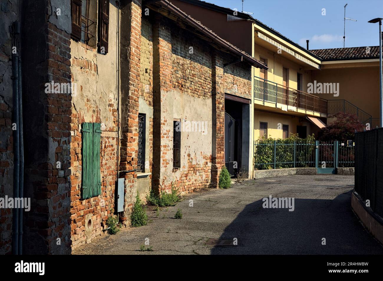 Street in a village with old brick houses on a sunny day in the italian ...