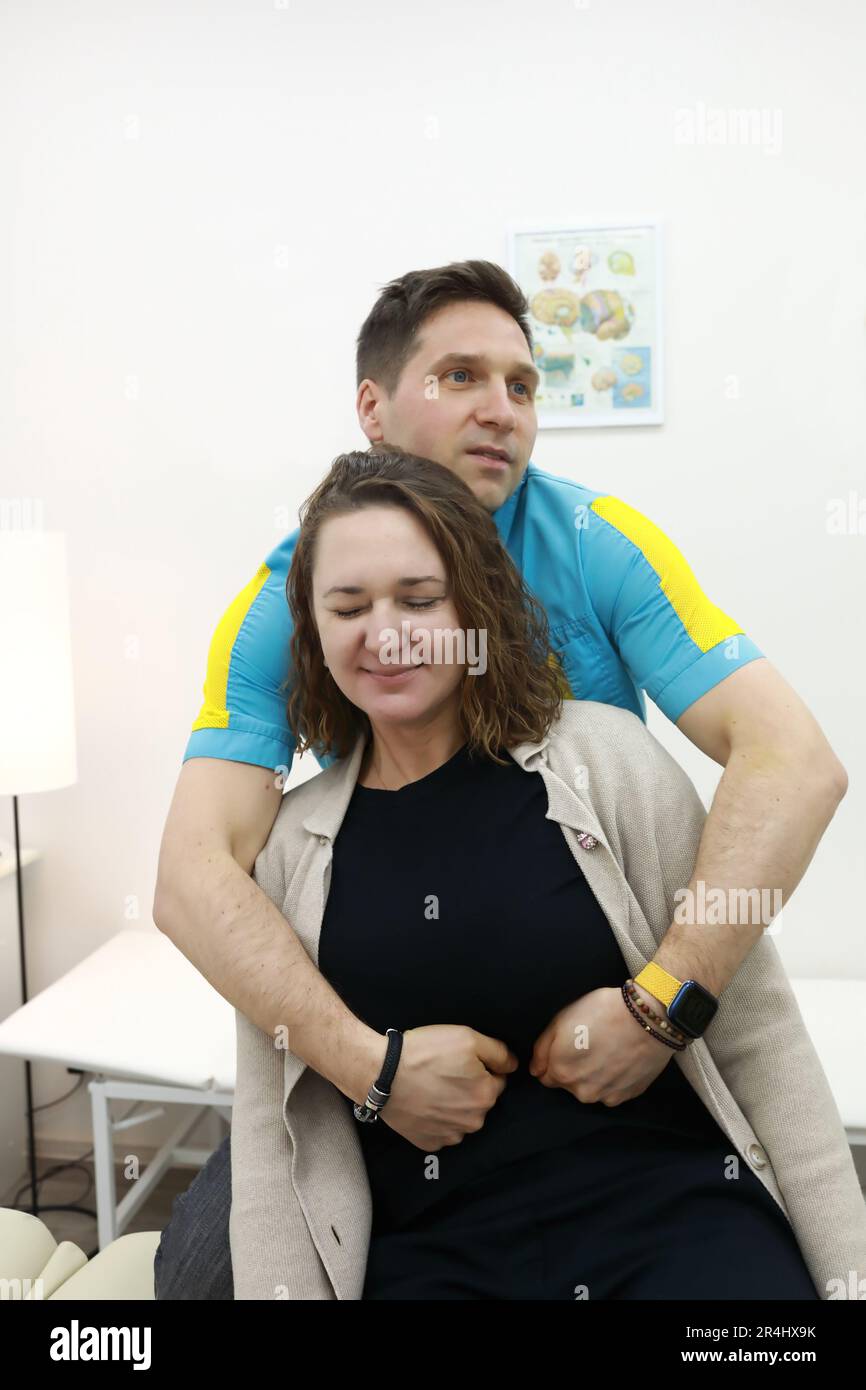 Osteopath corrects vagus nerve in woman in clinic Stock Photo