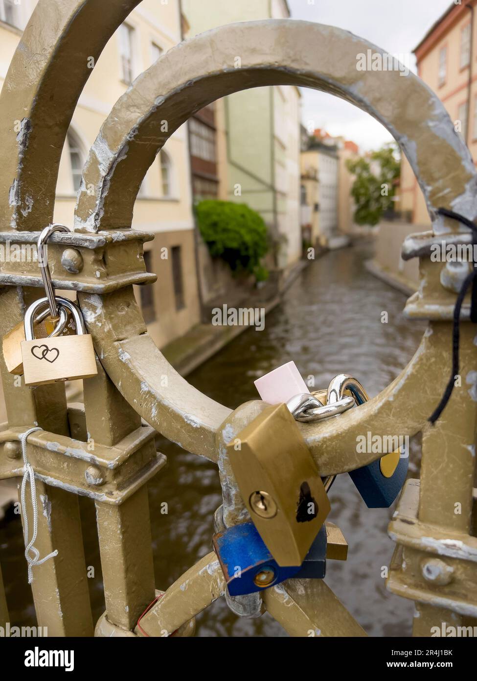 padlocks, hanged love padlocks on fence of a bridge over river and