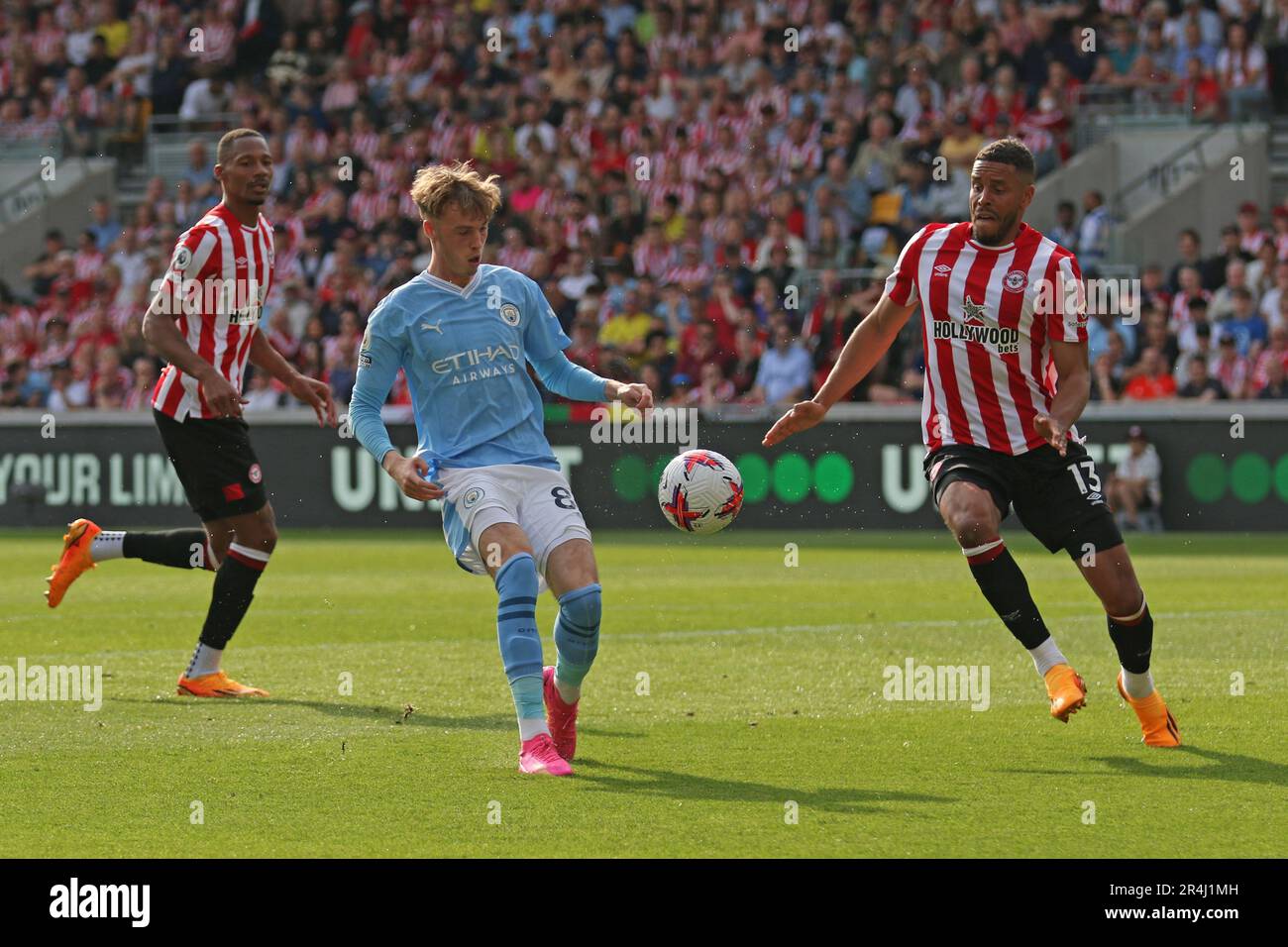 London, UK. 28th May, 2023. Cole Palmer of Manchester City and Mathias Zanka Jørgensen of Brentford challenging for the ball during the Premier League match between Brentford and Manchester City at Gtech Community Stadium, London, England on 28 May 2023. Photo by Pedro Soares. Editorial use only, license required for commercial use. No use in betting, games or a single club/league/player publications. Credit: UK Sports Pics Ltd/Alamy Live News Stock Photo