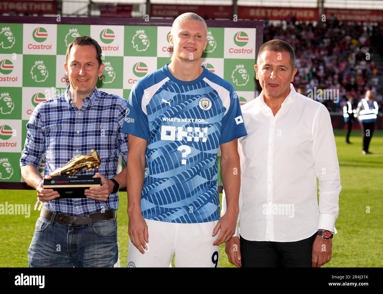 Manchester City's Erling Haaland is presented with the Castrol Golden Boot award by James Arnold and Jeremy Clark following the Premier League match at the Gtech Community Stadium, London. Picture date: Sunday May 28, 2023. Stock Photo