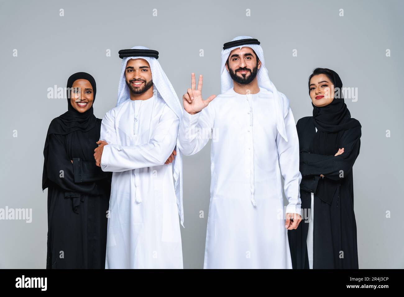 Beautiful arab middle-eastern women with traditional abaya dress and middle  easter man wearing kandora in studio - Group of arabic muslim adults portr  Stock Photo - Alamy