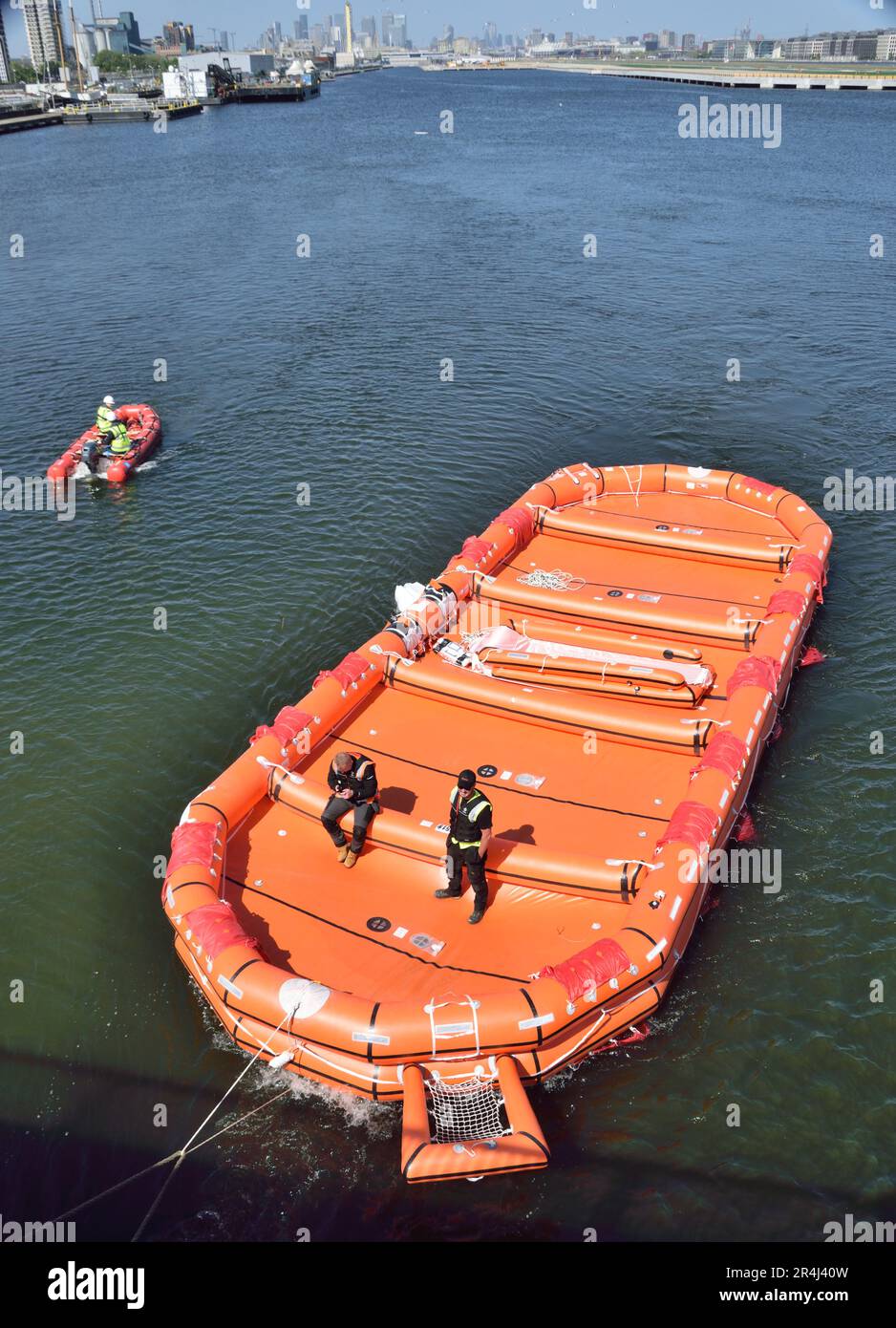 The new battery powered entertainment vessel OceanDiva London undergoing life-raft trials in London's Royal Docks Stock Photo