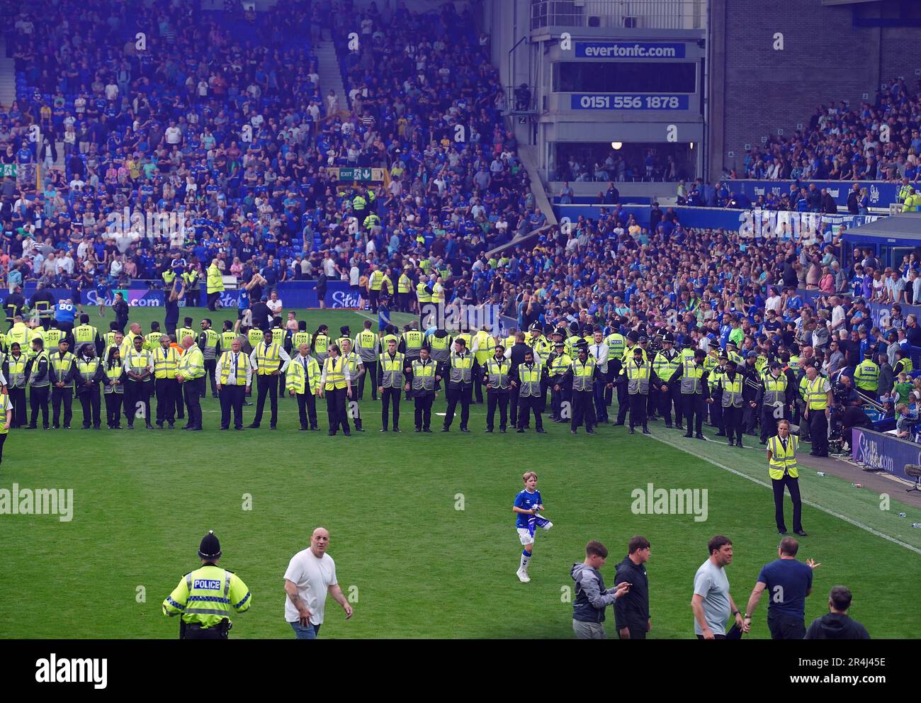 Everton fans invade the pitch after securing their safety by winning ...