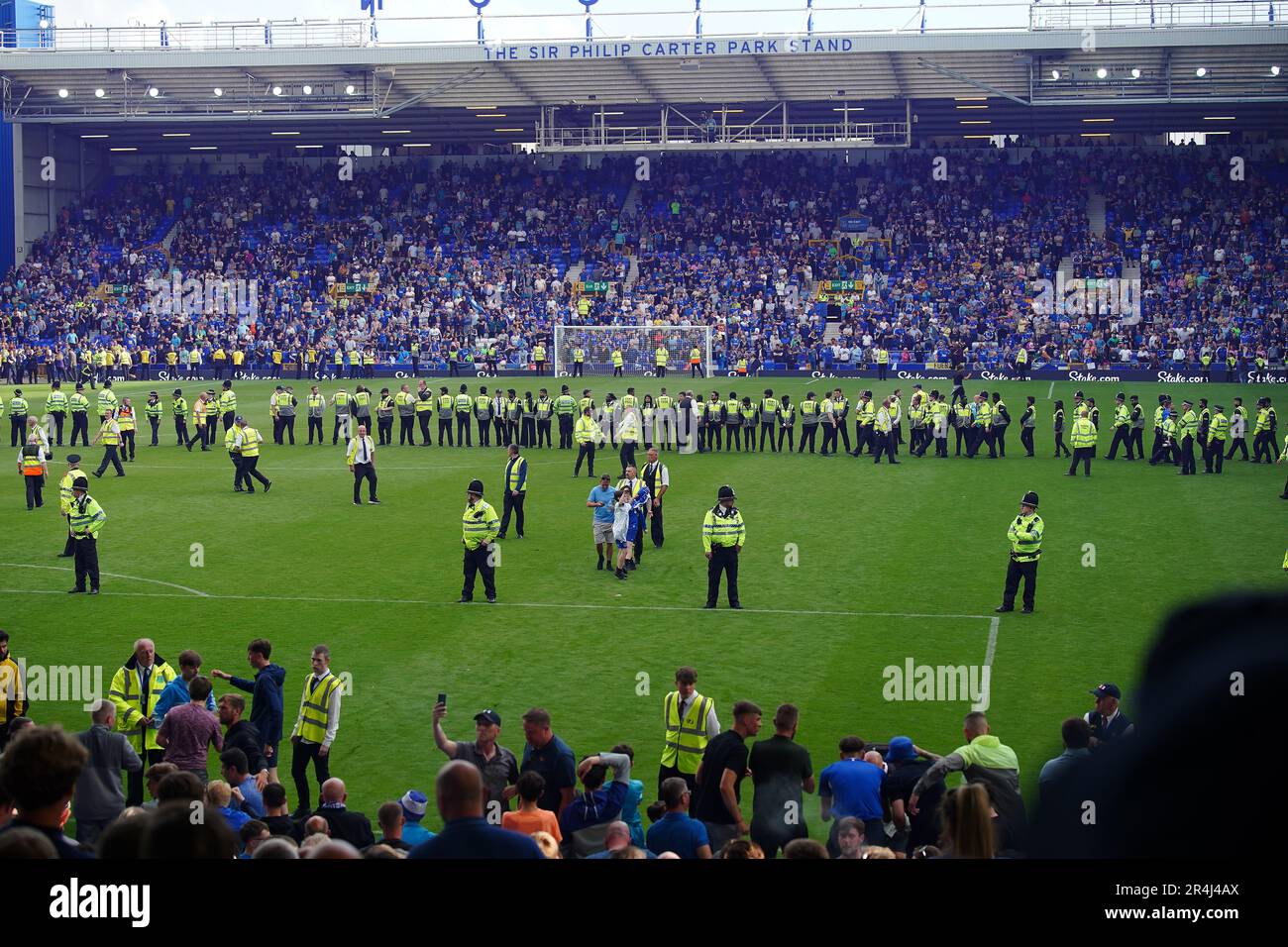 Everton fans invade the pitch after securing their safety by winning ...