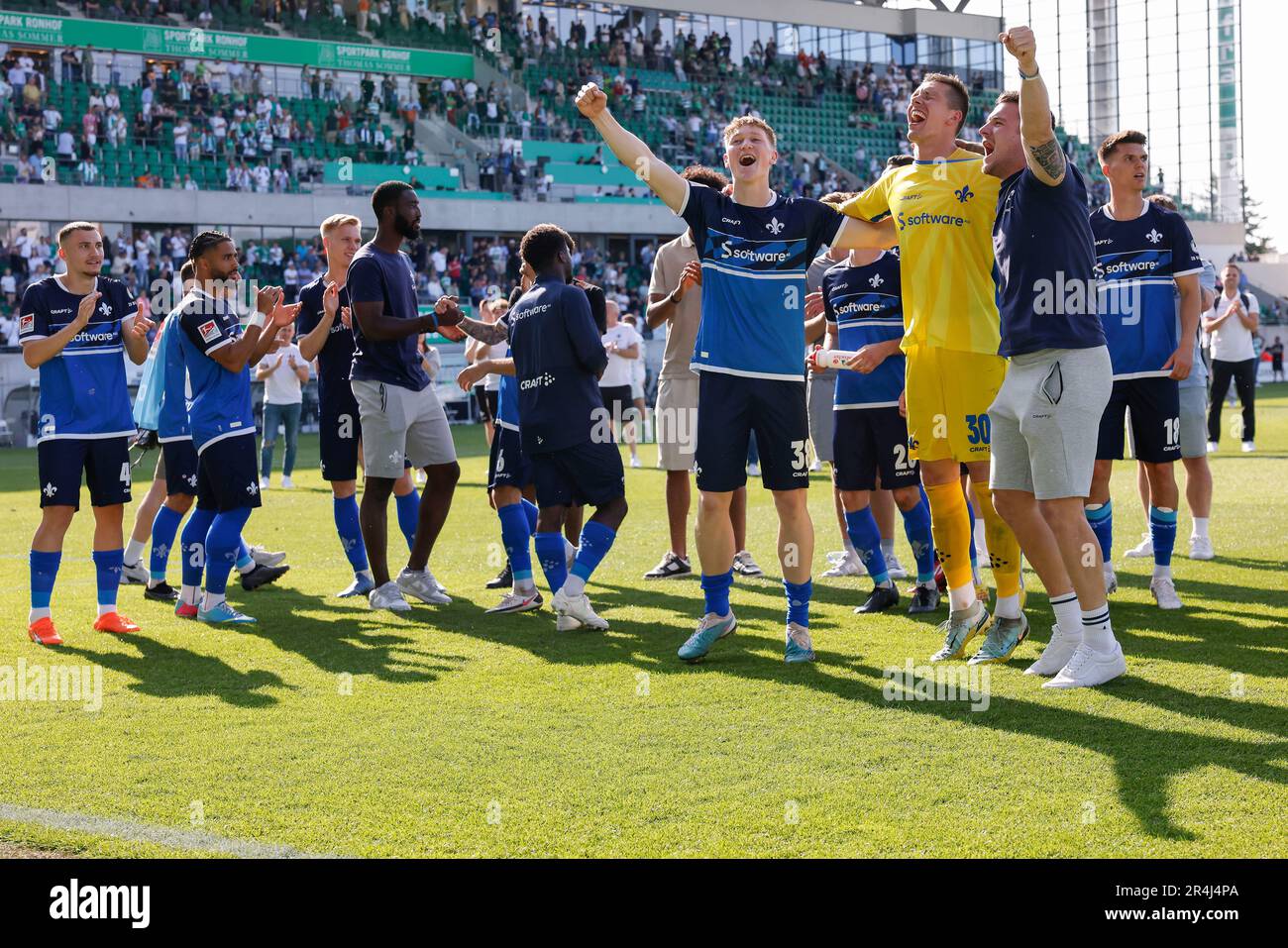 28 May 2023, Bavaria, Fürth: Soccer: 2nd Bundesliga, SpVgg Greuther Fürth - Darmstadt 98, Matchday 34, Sportpark Ronhof Thomas Sommer. Darmstadt's Clemens Riedel (l-r), goalkeeper Alexander Brunst and Marcel Schuhen celebrate promotion on the pitch. Photo: Daniel Löb/dpa - IMPORTANT NOTE: In accordance with the requirements of the DFL Deutsche Fußball Liga and the DFB Deutscher Fußball-Bund, it is prohibited to use or have used photographs taken in the stadium and/or of the match in the form of sequence pictures and/or video-like photo series. Stock Photo