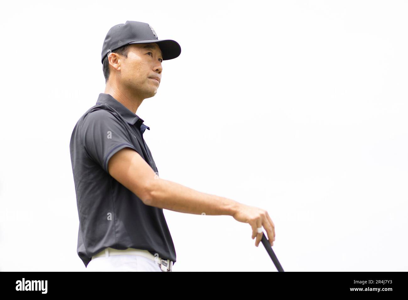 Captain Kevin Na of Iron Heads GC looks on from the driving range