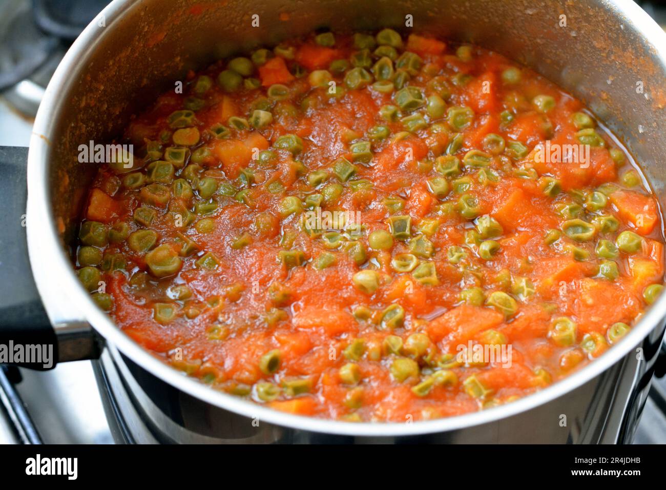 cooked slices of carrots and peas with tomato sauce, high in vitamins like vitamin A and vitamin