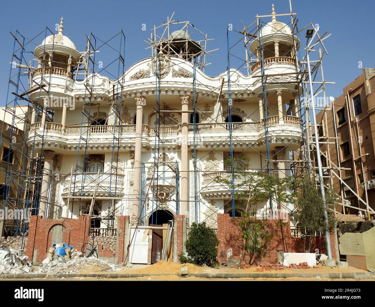 Cairo, Egypt, May 10 2023: A new residential building villa under construction with scaffoldings on the buildings for painting and finishing the exter Stock Photo