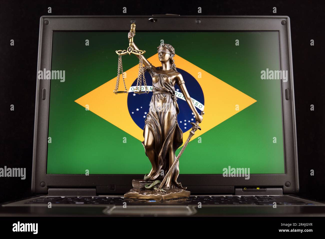 Symbol of law and justice with Brazil Flag on laptop. Studio shot. Stock Photo