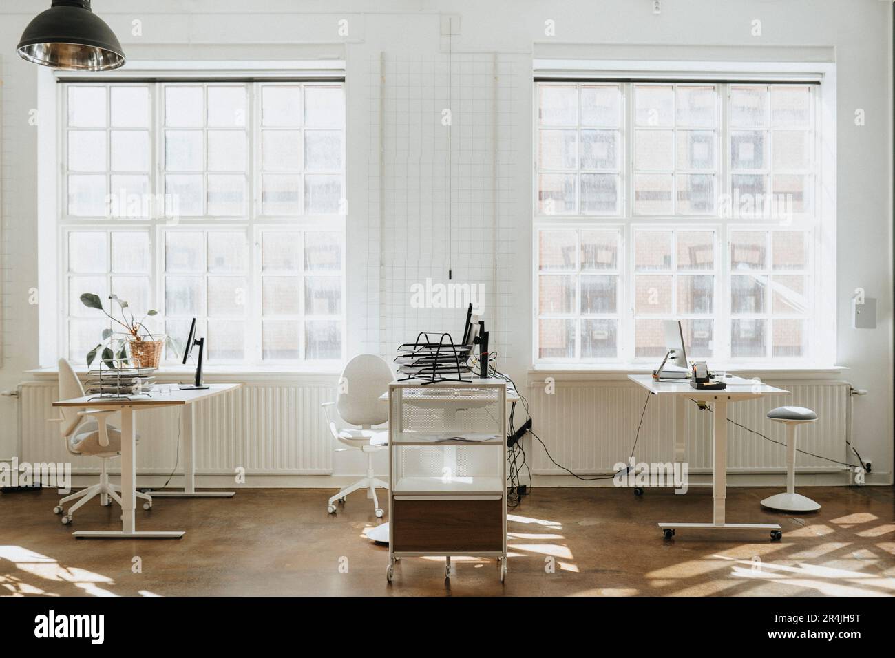 Empty corporate office with computers on desk near window Stock Photo