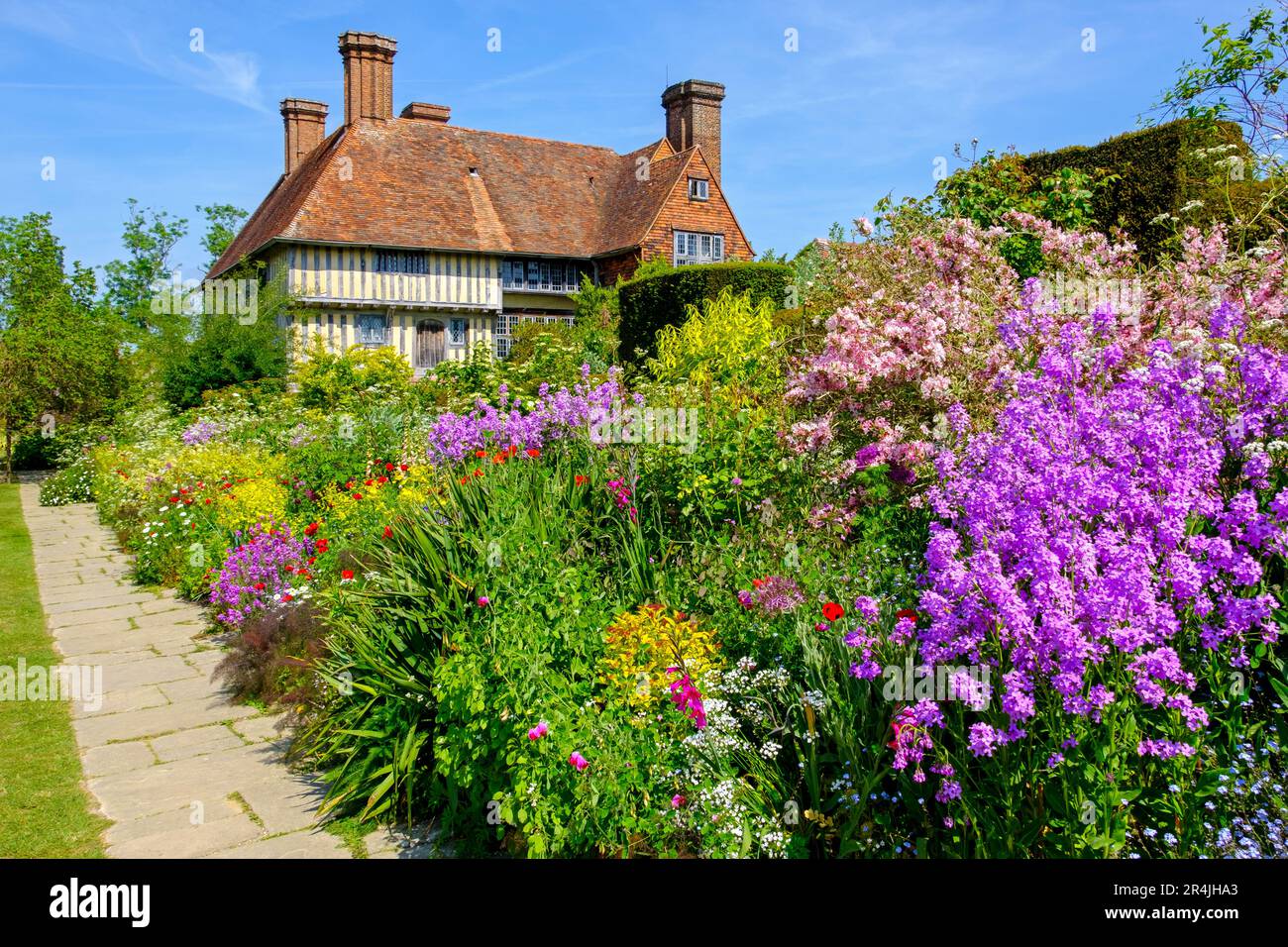 Great Dixter house and garden, the colourful long border in spring, East Sussex, UK Stock Photo
