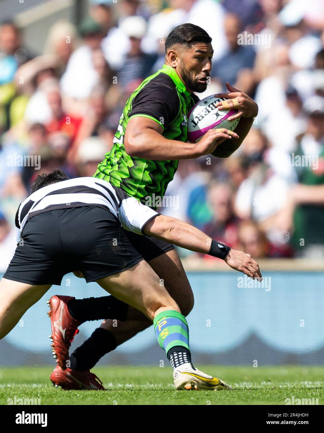 Charles Piutau of the World XV is tackled during the Killik Cup match