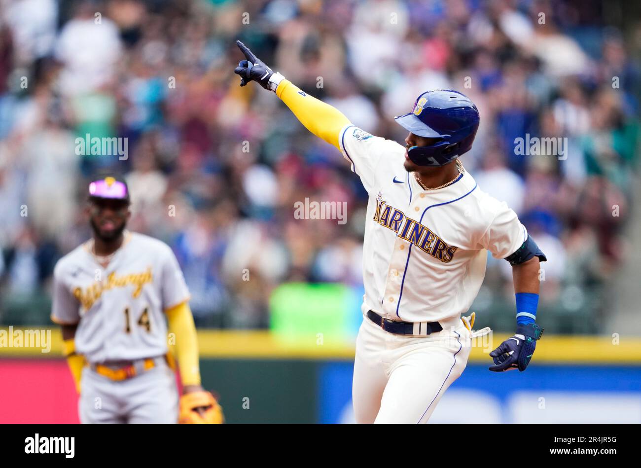 Seattle Mariners' Julio Rodriguez points as he runs the bases after