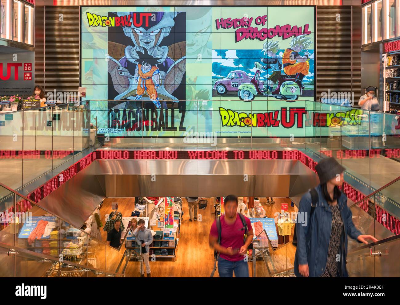 tokyo, harajuku - may 10 2023: Interior view of a Japanese Uniqlo store with a wall covered in large screen advertising artwork featuring the popular Stock Photo