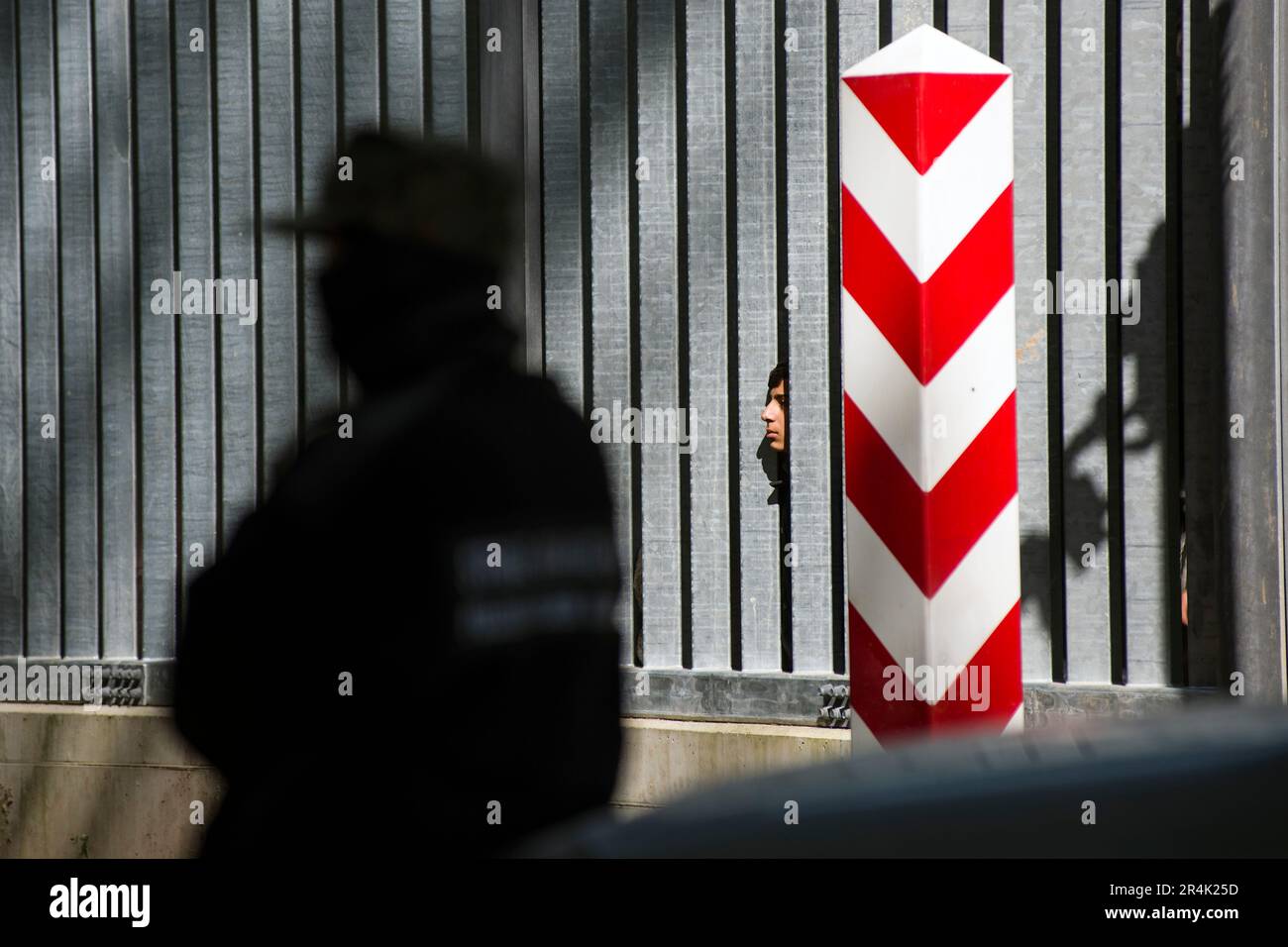 Polish border guards are seen watching the migrants who are stuck at the Polish border wall in Bialowieza. A group of 30 migrants and refugees from Iraq and Syria seeking asylum, including more than 10 children, has been stuck at Poland's border wall with Belarus for three days. Belarusian border guards are not allowing them to turn back to Belarus. Activist Marta Staniszewska form the Grupa Granica (Border Group) organization, who spoke with the migrants, said, that 'Belarusian services told the migrants if they return, they will be beaten, or that they will even kill them”. Stock Photo