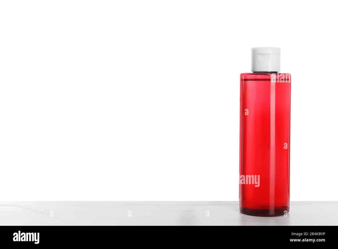 Micellar water on table against white background. Space for text Stock Photo